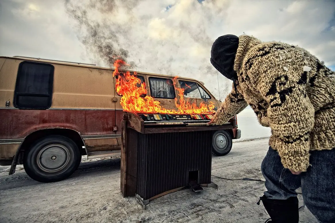 Burning organ beside a van on the ice, 2011