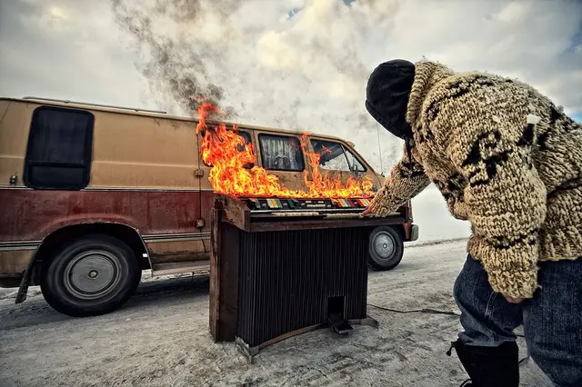 Burning organ beside a van on the ice